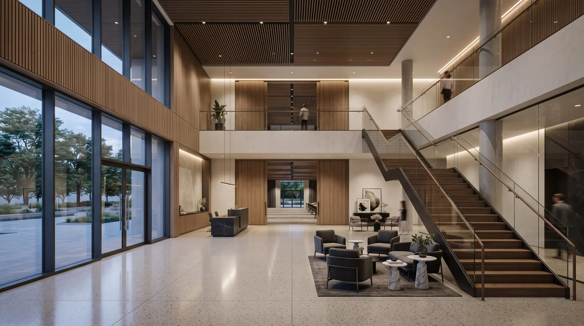 Double-height modern function hall with full-height glazing, a central staircase and lounge seating